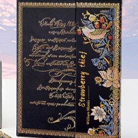 Decorative box with ornate text and floral designs on a blue background