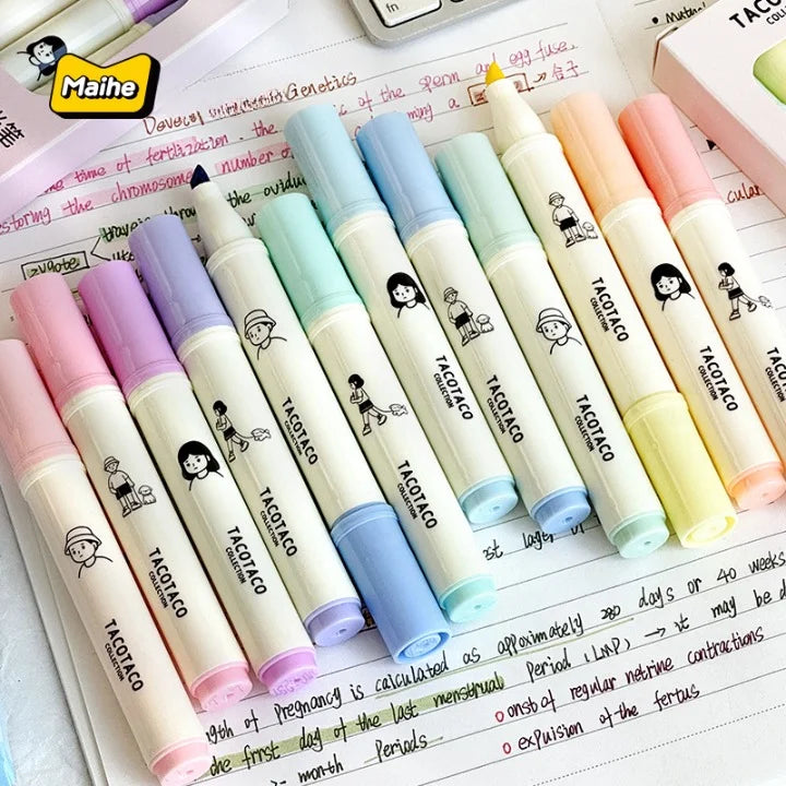 Set of colorful markers with cartoon character design on a notebook page.