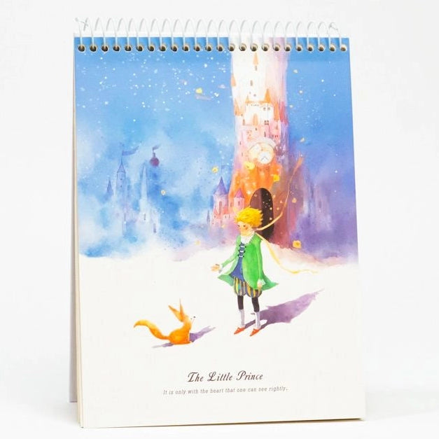 Wandkalender mit Illustrationen von 'The Little Prince' auf einem weißen Hintergrund