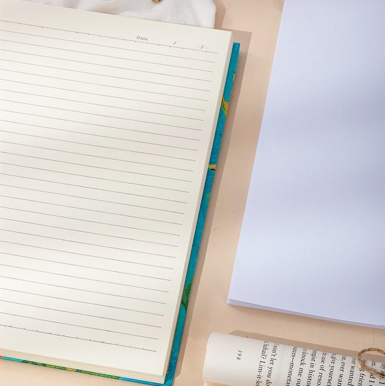 Notebook, pen, and paper on a beige surface with text overlay