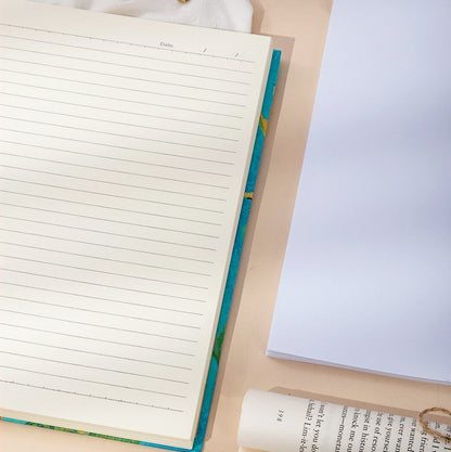 Notebook, pen, and paper on a beige surface with text overlay