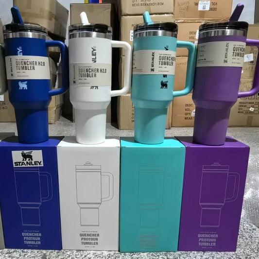 Five colorful tumblers on their respective boxes with 'Stanley' branding.