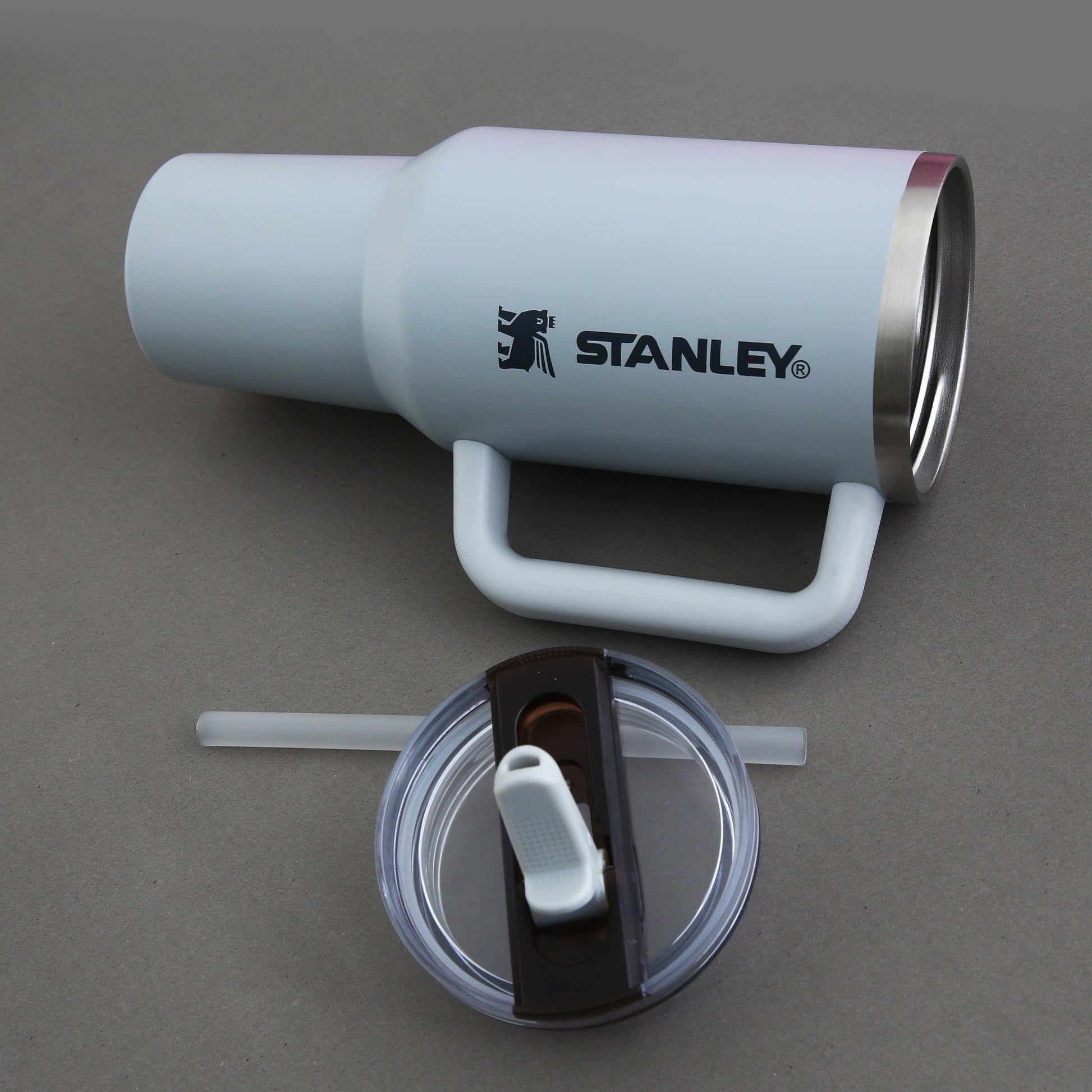 Stanley insulated tumbler with handle on a gray background