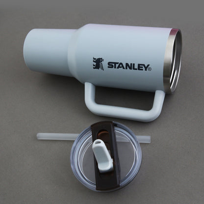 Stanley insulated tumbler with handle on a gray background