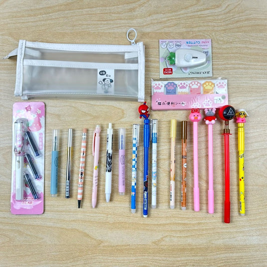 Assorted stationery items including pens and a pencil case on a wooden surface