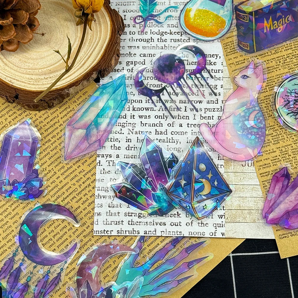 Colorful crystal and cat-shaped stickers on a textured surface with text