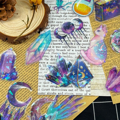 Colorful crystal and cat-shaped stickers on a textured surface with text