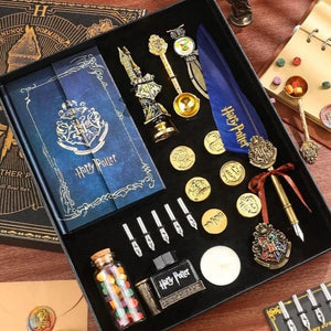 A collection of Harry Potter themed stationery supplies including a journal, pen holder, stamps, bookmarks, wax seal stamp, ink bottle, badge, feather pen, and wax.