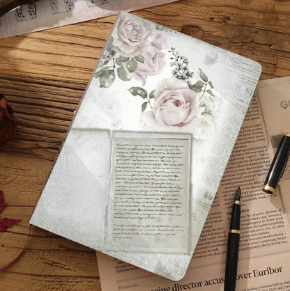 Floral notebook on a wooden surface with a pen