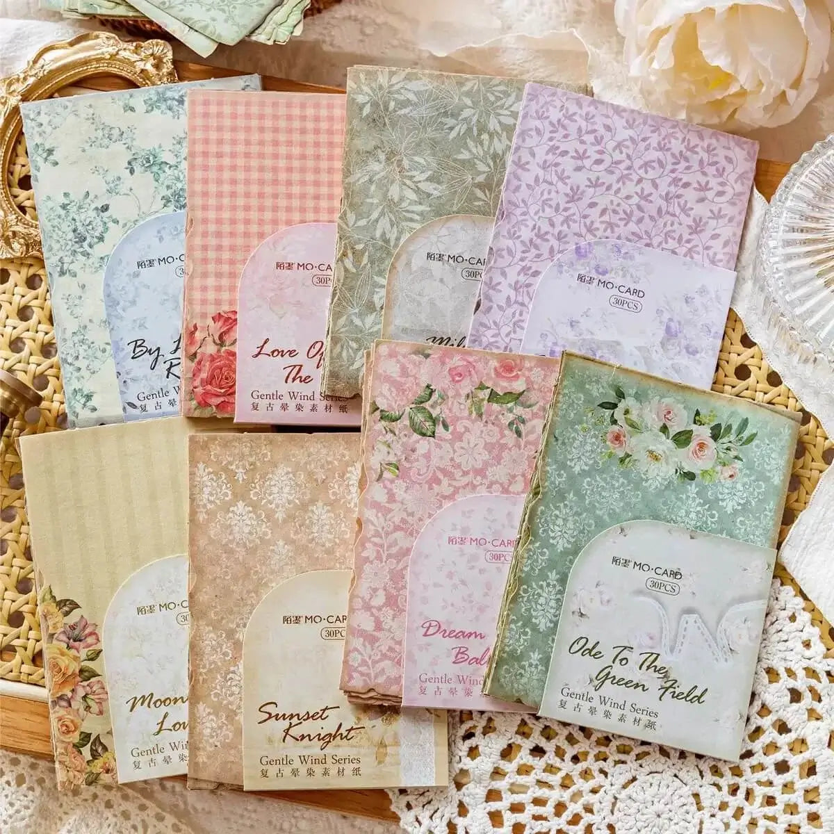 Set of decorative cards with floral and text designs on a textured surface.