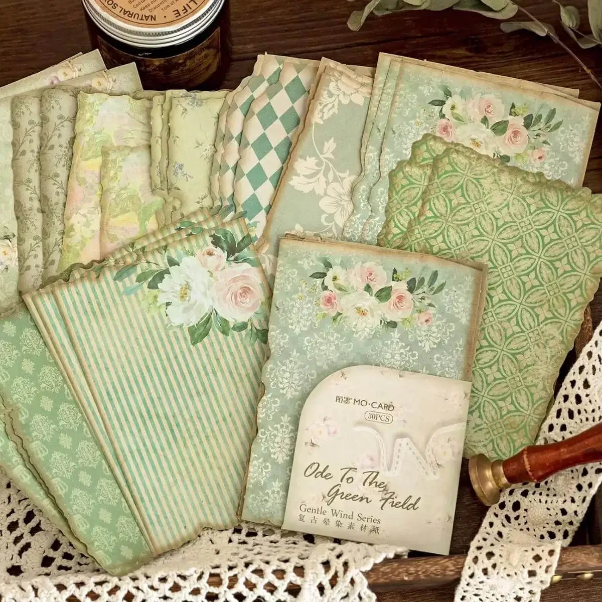 Collection of vintage-style greeting cards with floral and patterned designs on a lace doily.