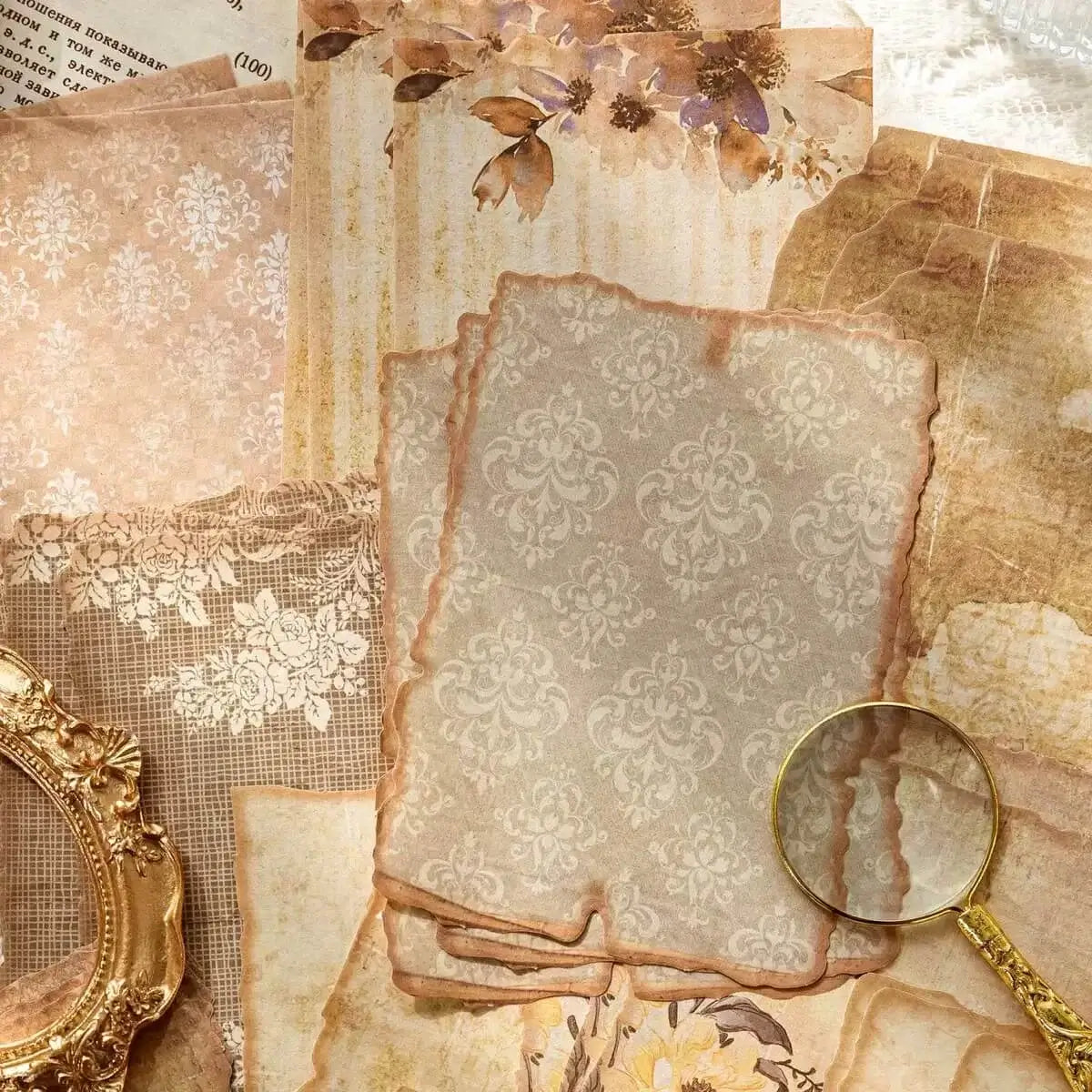 Vintage-style paper with floral and lace patterns, a magnifying glass, and a gold frame.