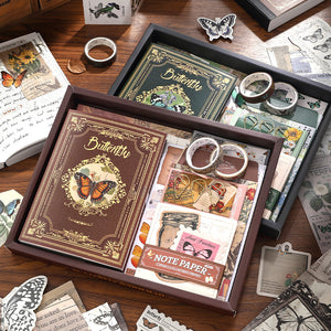 Decorative stationery set with butterfly-themed items on a wooden surface