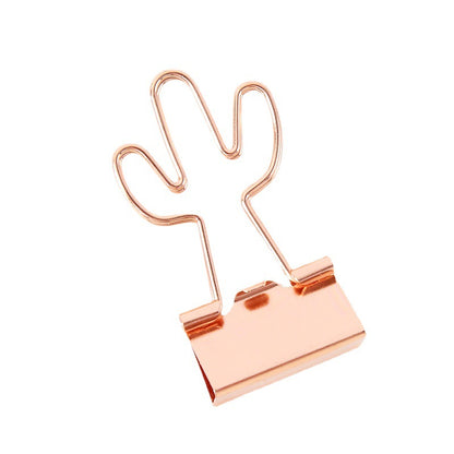 Rose gold binder clip on a white background