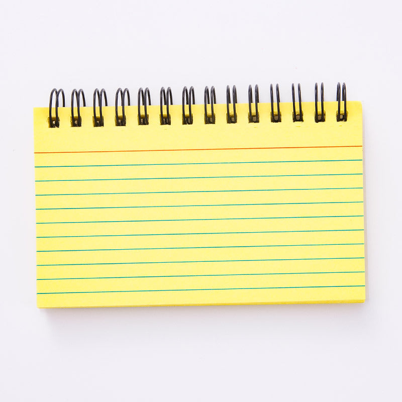 A collection of colorful coil-lined flash cards and a notepad with a wrist strap, laying on a wicker surface.