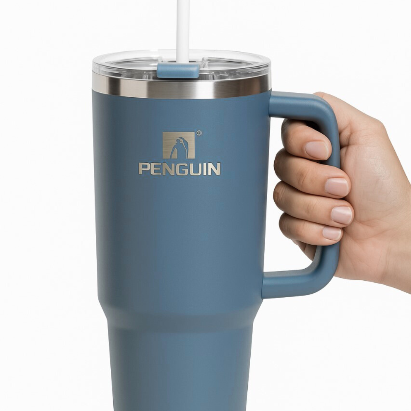 Blue insulated mug with handle held by a hand on a white background, featuring the Penguin brand.