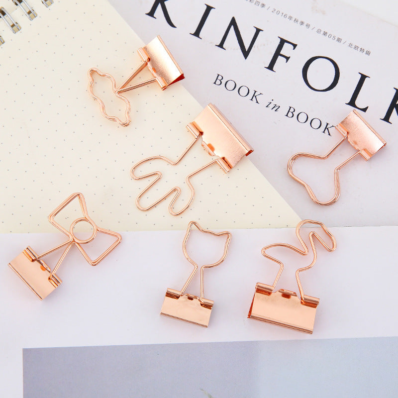 Rose gold paper clips on a magazine with 'KINFOLK' branding