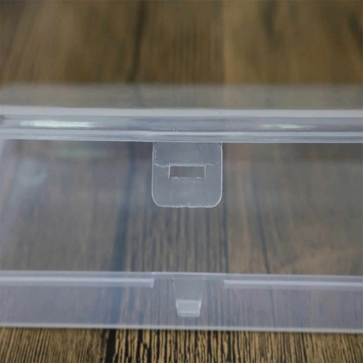 Clear plastic storage box on a wooden surface