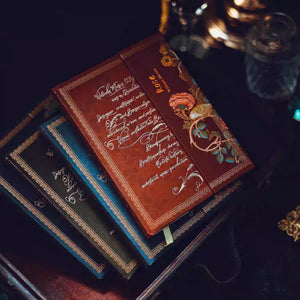 Decorative books with intricate designs on a dark surface