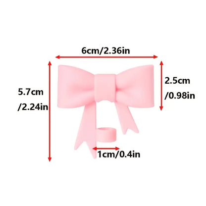 Measurement chart of a pink bow with dimensions labeled in centimeters and inches.