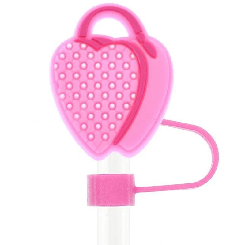 Pink heart-shaped tool with a handle on a white background