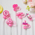 Set of pink Barbie-themed strawlers on a white background with flowers and a lemon.