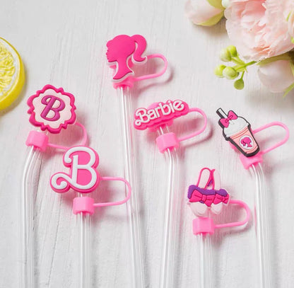 Set of pink Barbie-themed strawlers on a white background with flowers and a lemon.