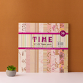A pack of decorative journaling paper with floral patterns displayed against an orange background, with a small potted plant to the side.