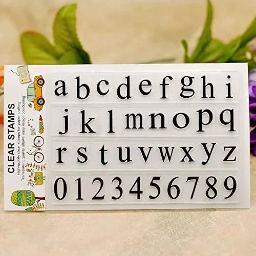 Alphabet and number stamps on a white card with decorative elements.
