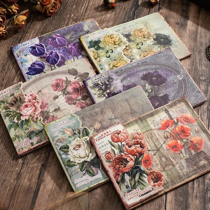 Set of decorative greeting cards with floral designs on a wooden surface