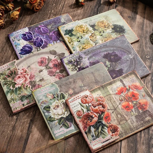 Set of decorative greeting cards with floral designs on a wooden surface
